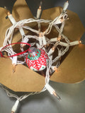 Small Hand Painted White Glass Ornament with Red and Green Henna Art